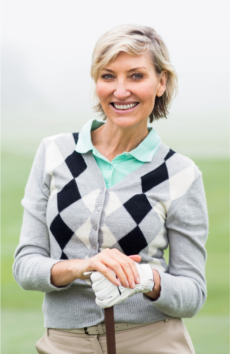 smiling woman while golfing